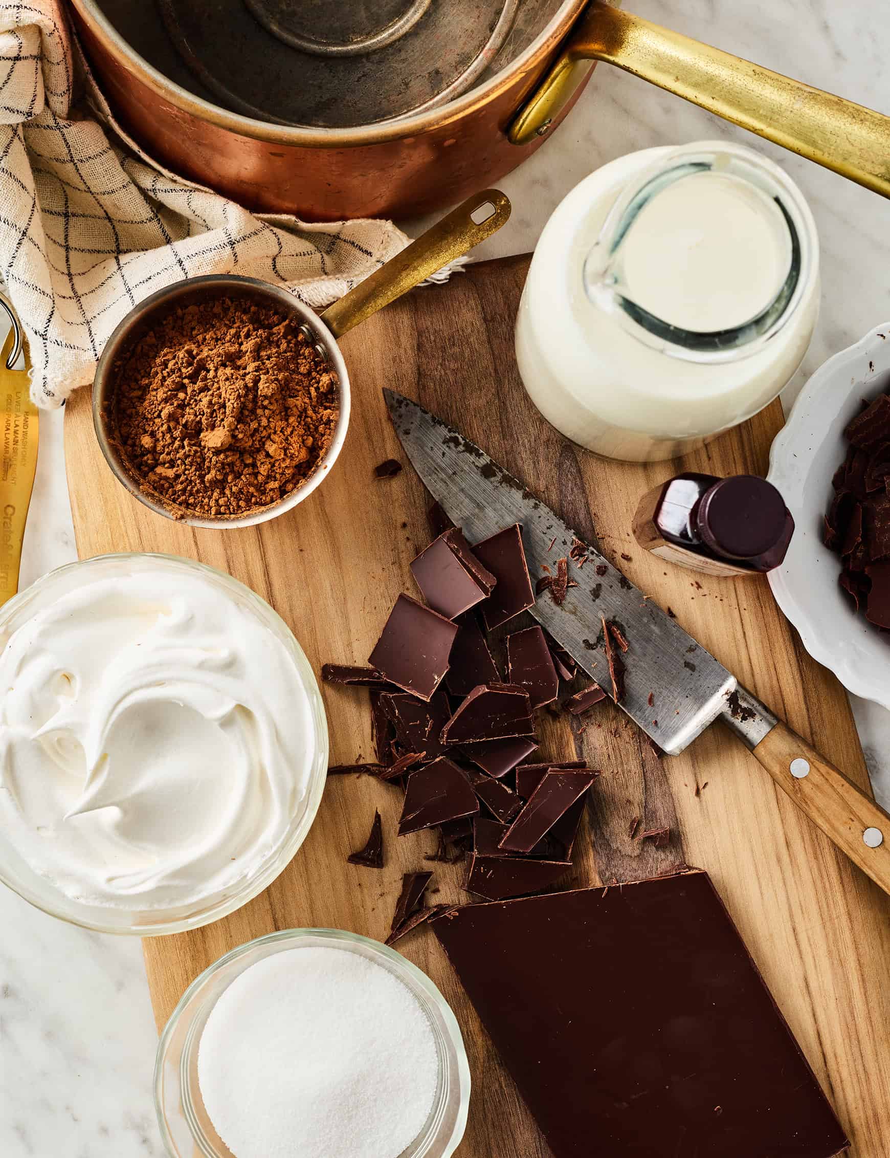 Recipe ingredients: chopped chocolate, milk, sugar, cocoa powder, vanilla, and whipped cream