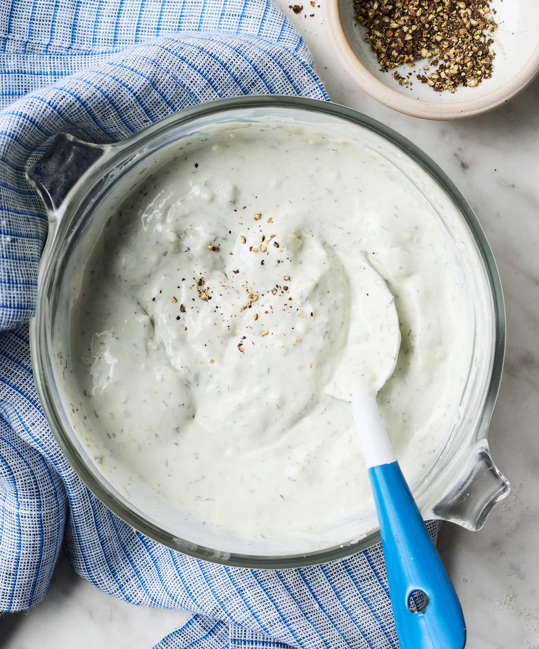 Creamy homemade blue cheese dressing in glass bowl