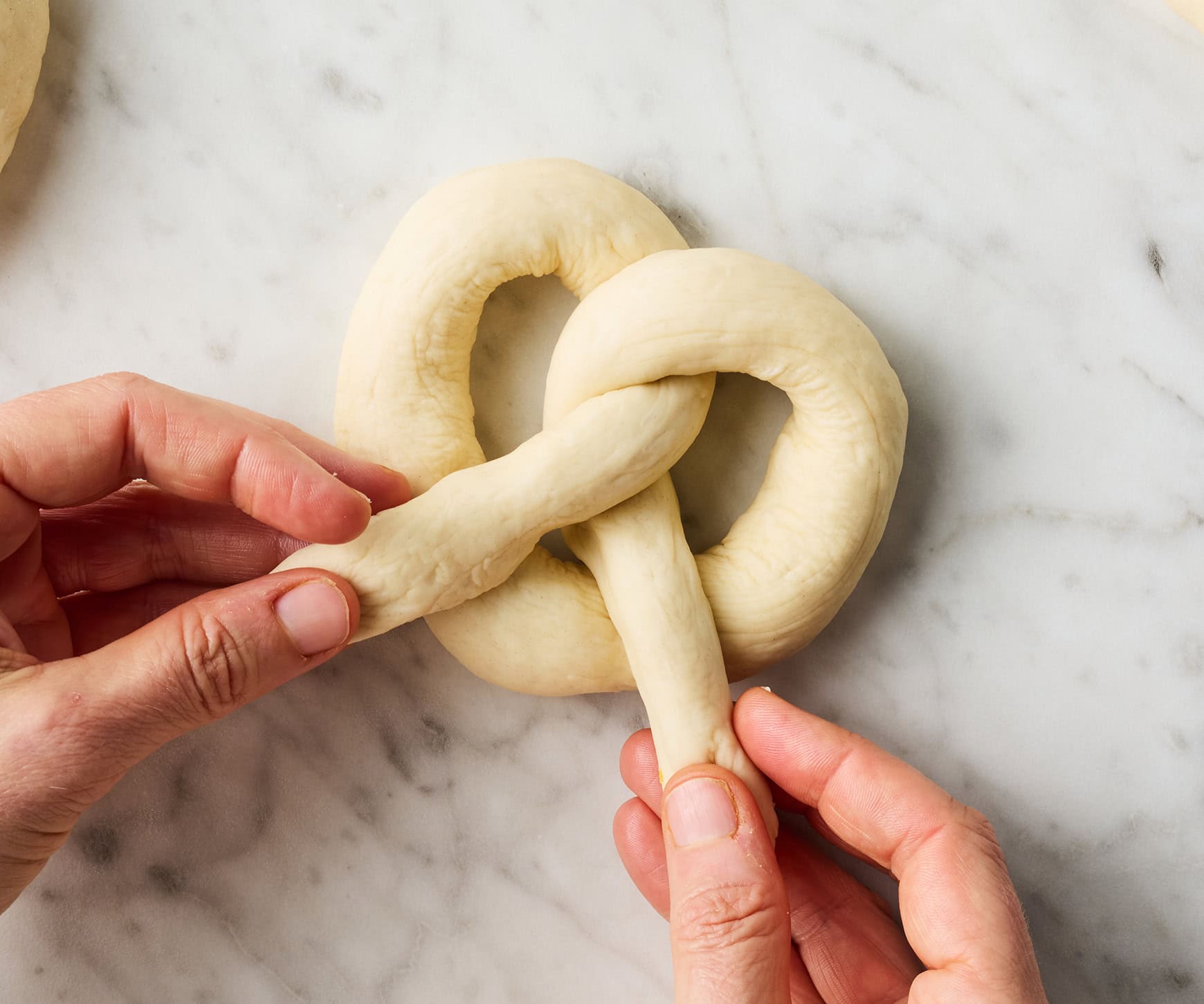 Forming dough into pretzel shape
