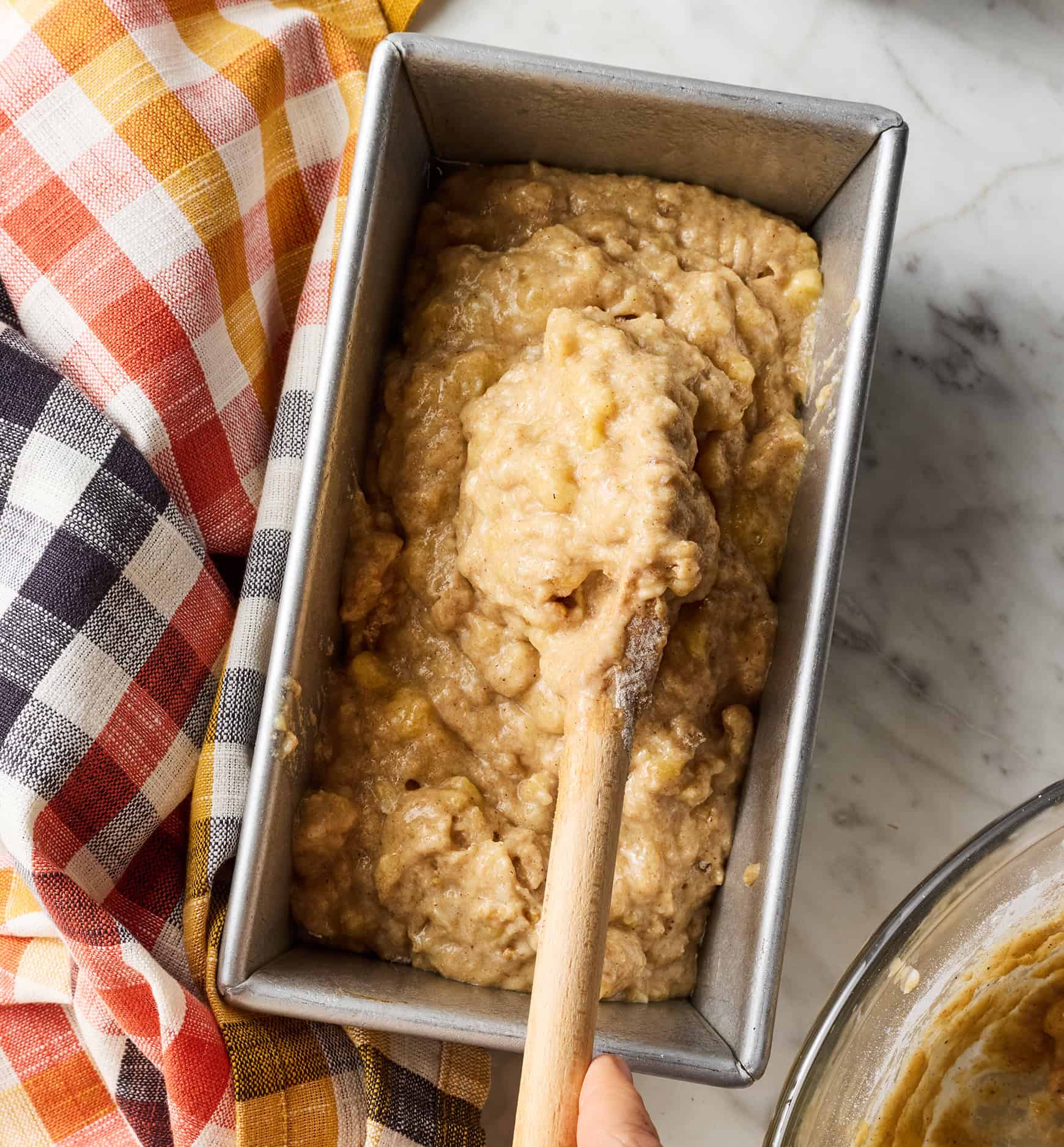 Spooning batter into loaf pan