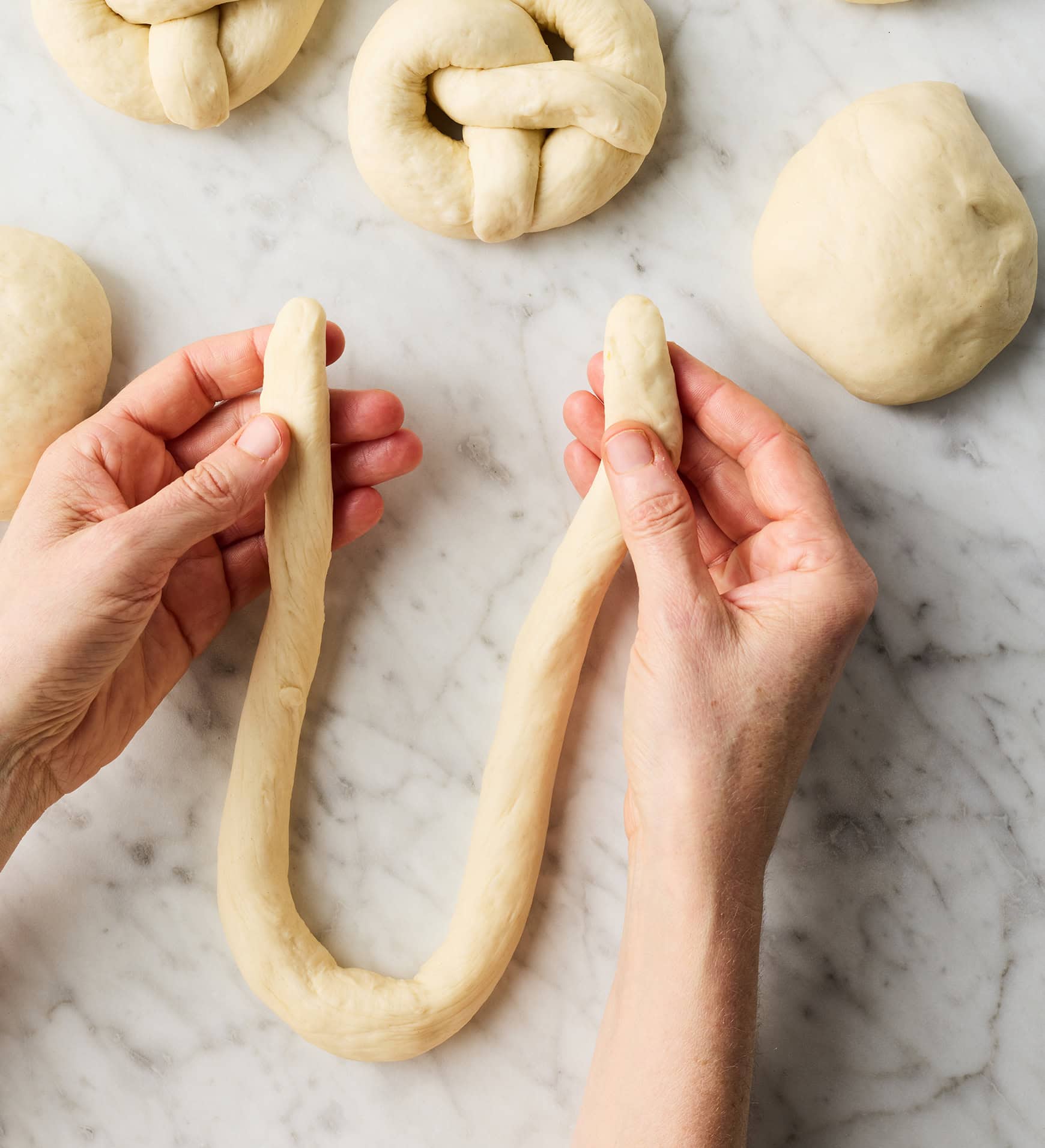 Forming dough rope into U-shape