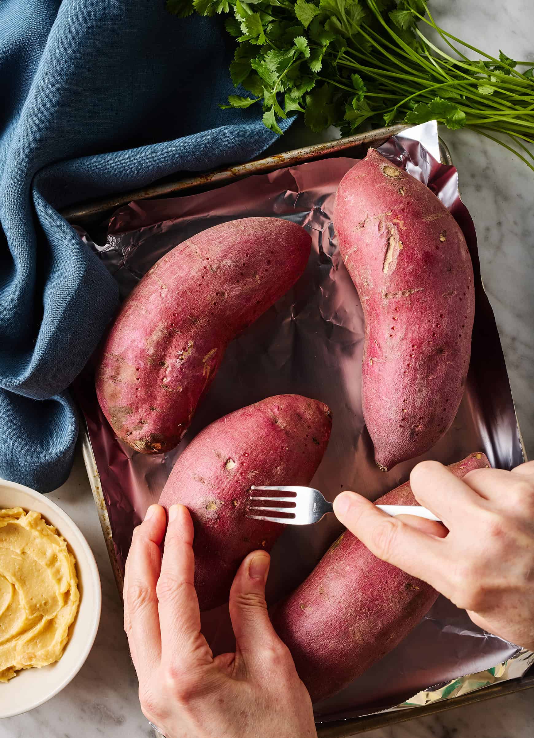 Pricking potato skin with fork