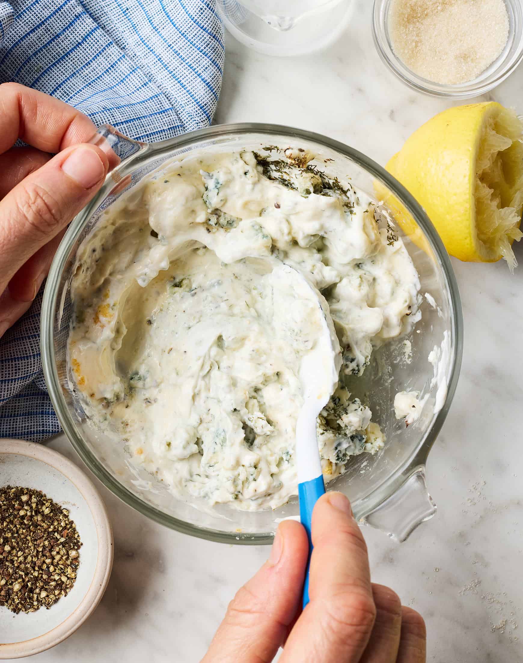 Mixing dressing in glass bowl