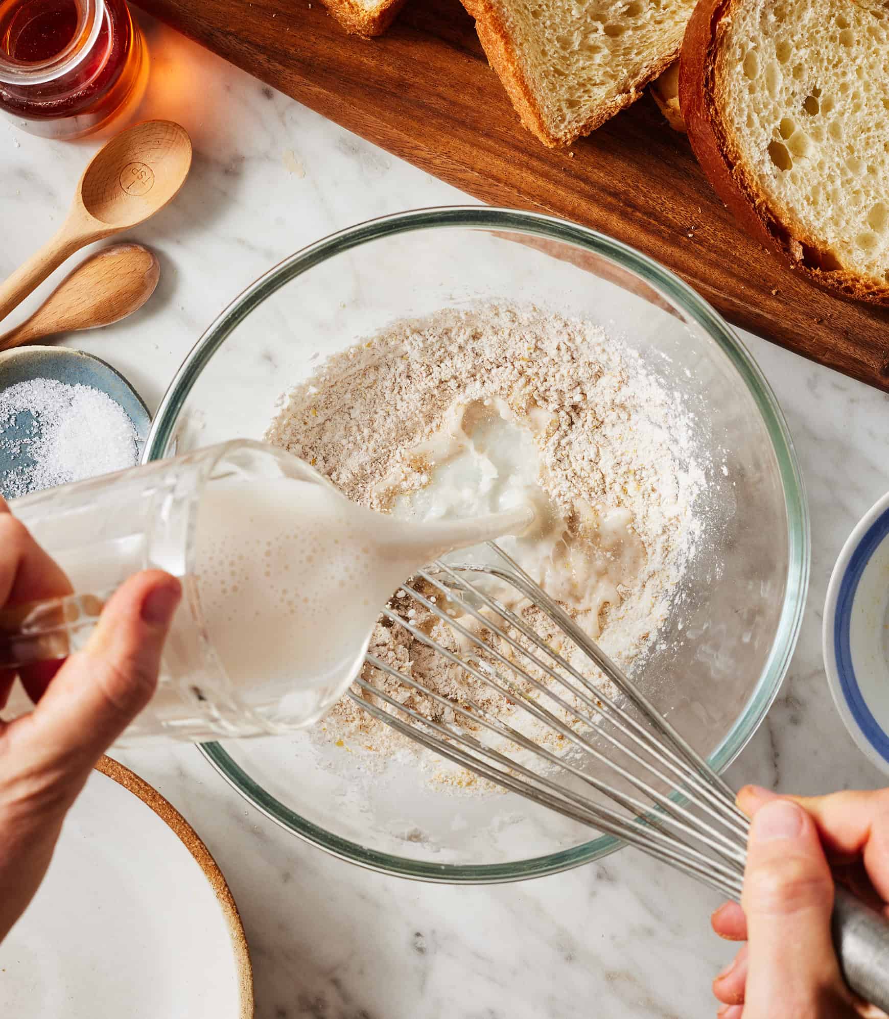 Pouring almond milk into bowl with cornstarch mixture
