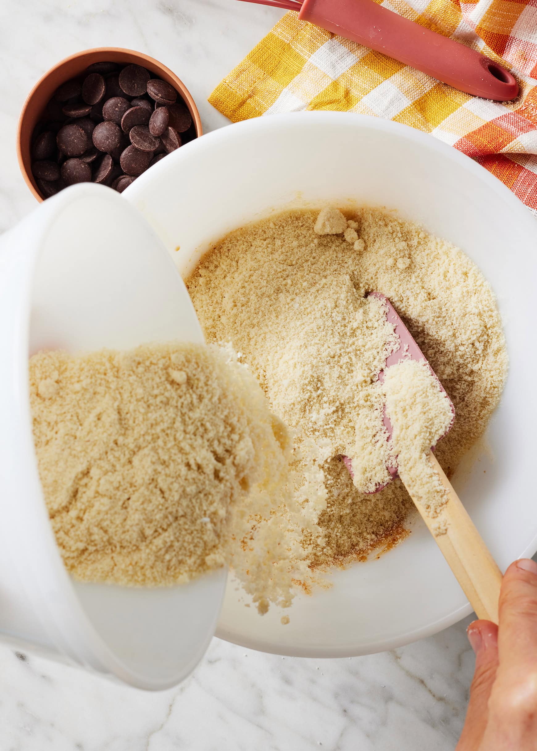 Pouring almond flour into mixing bowl