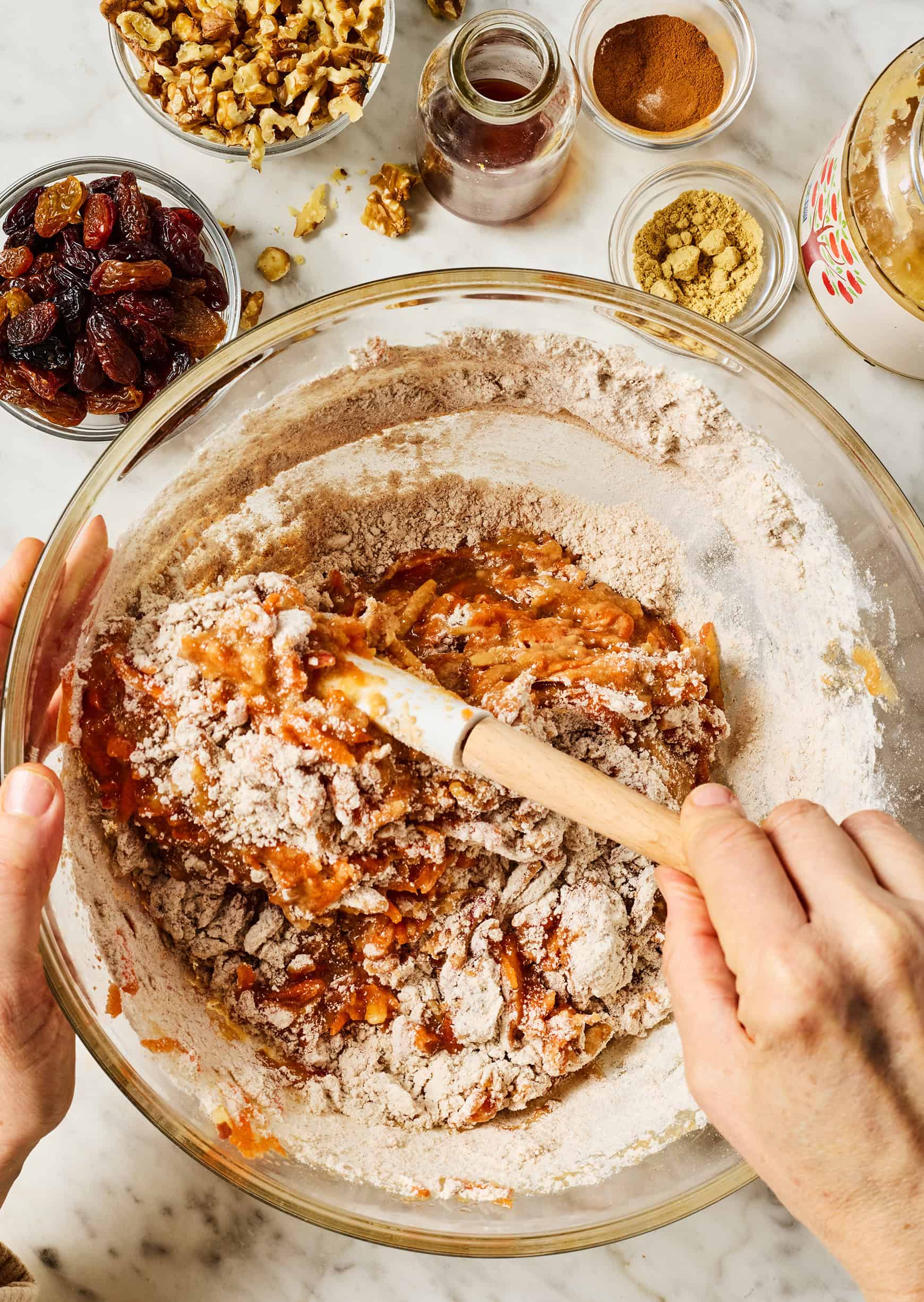 Mixing morning glory muffin batter in large bowl