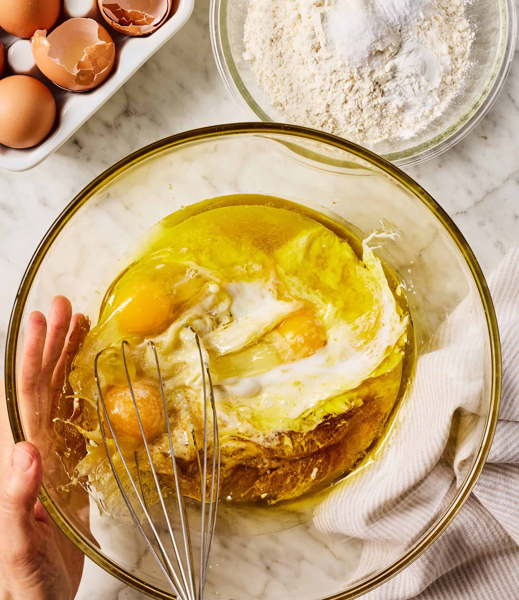 Whisking wet ingredients in glass mixing bowl