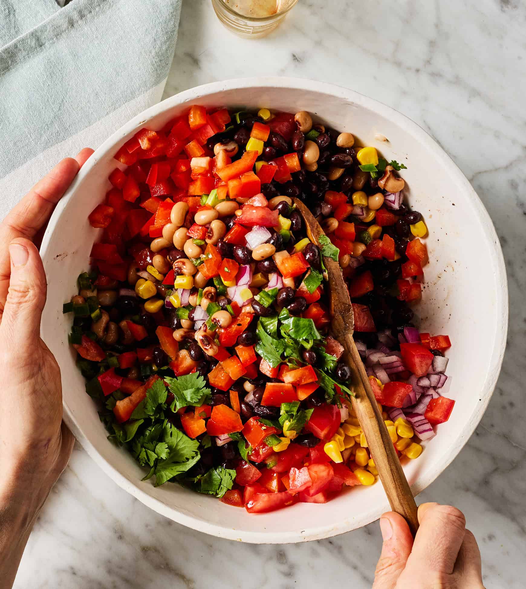 Mixing Texas caviar recipe ingredients in bowl