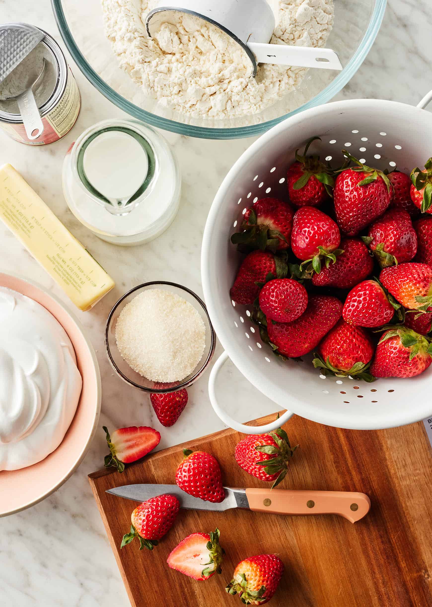 Strawberry shortcake recipe ingredients on marble countertop