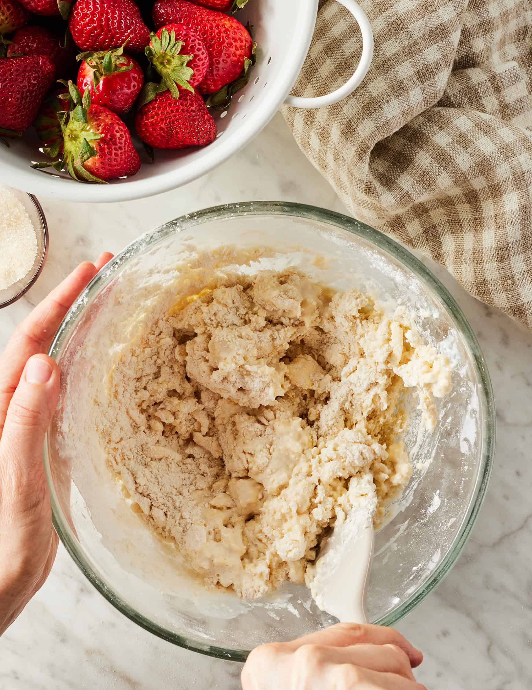 Mixing shaggy dough with spatula
