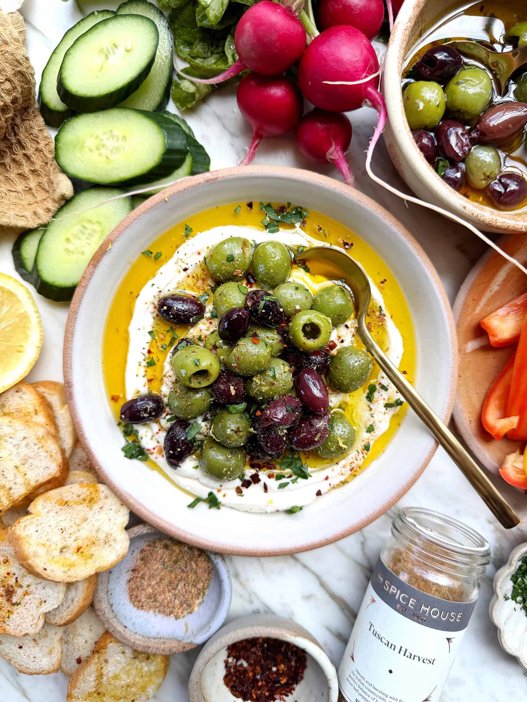 Marinated olives with whipped ricotta in serving dish