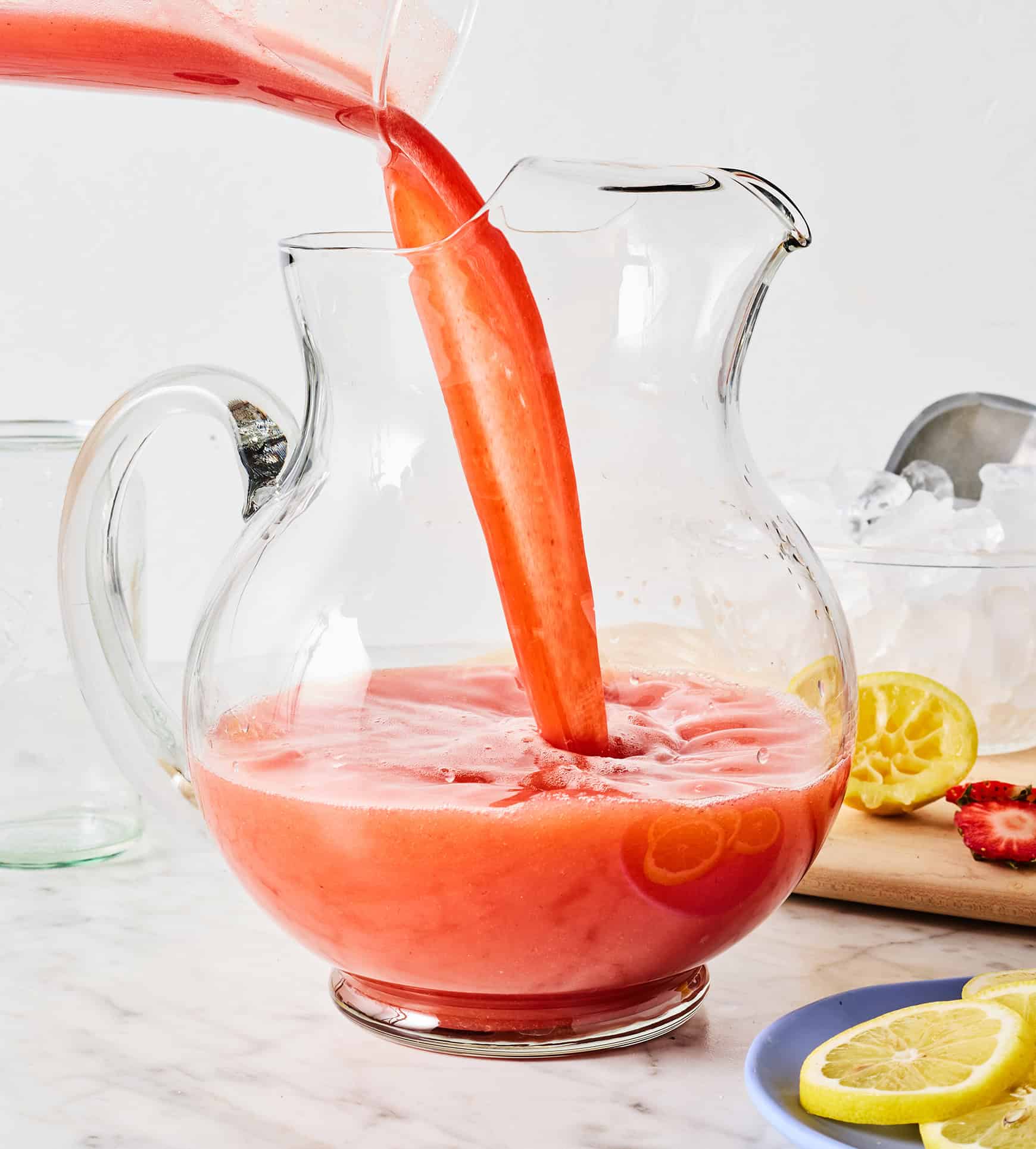 Pouring strawberry puree into large pitcher