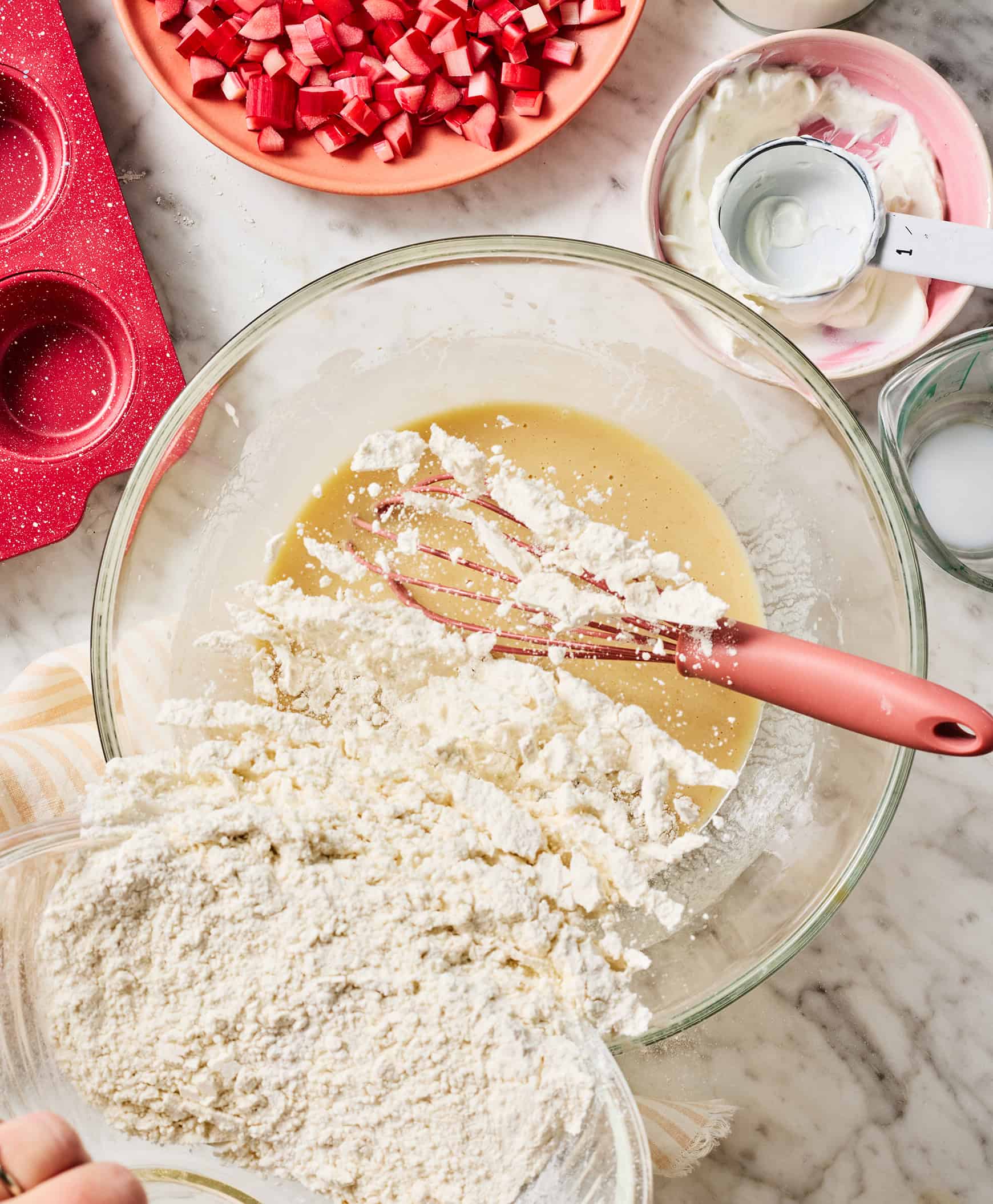 Adding dry ingredients to wet ingredients in bowl