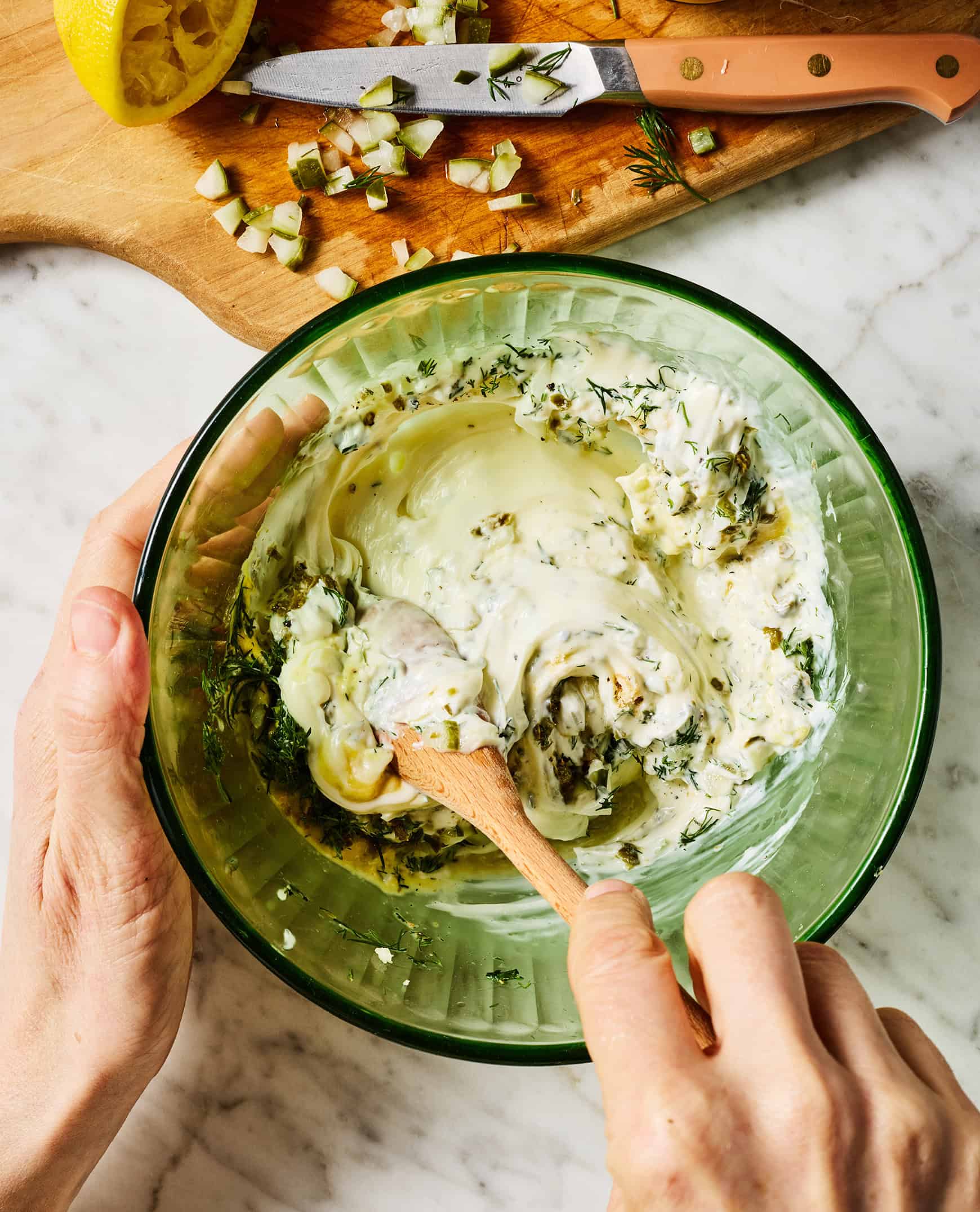 Stirring homemade tartar sauce in medium bowl