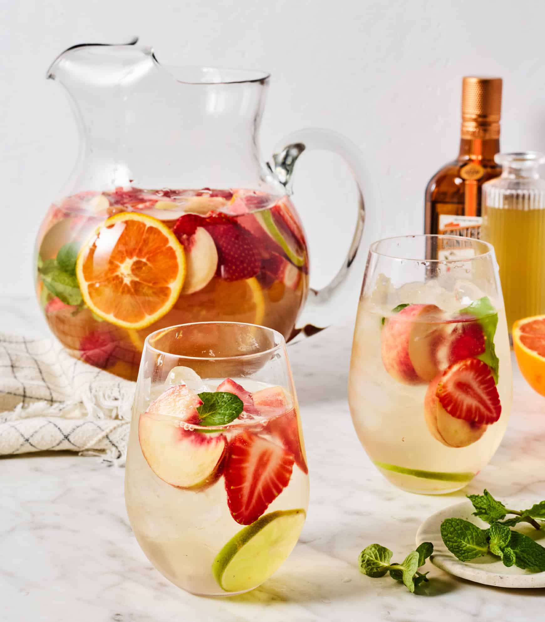 Two glasses of white sangria with fruit