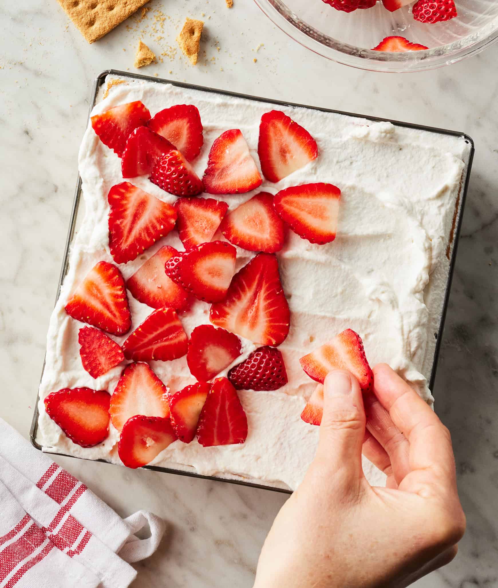 Topping icebox cake with fresh strawberries