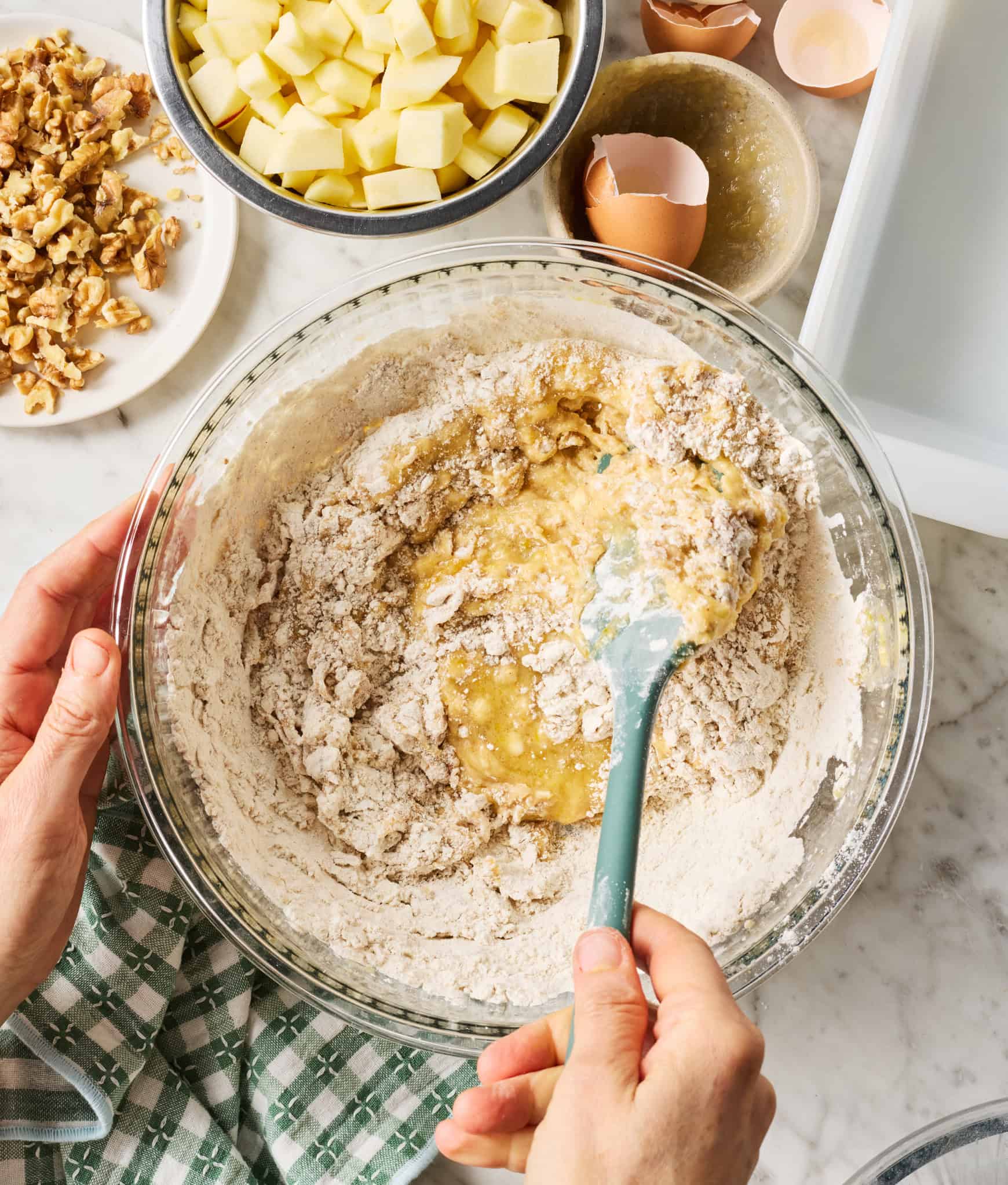 Mixing wet and dry ingredients together in glass bowl
