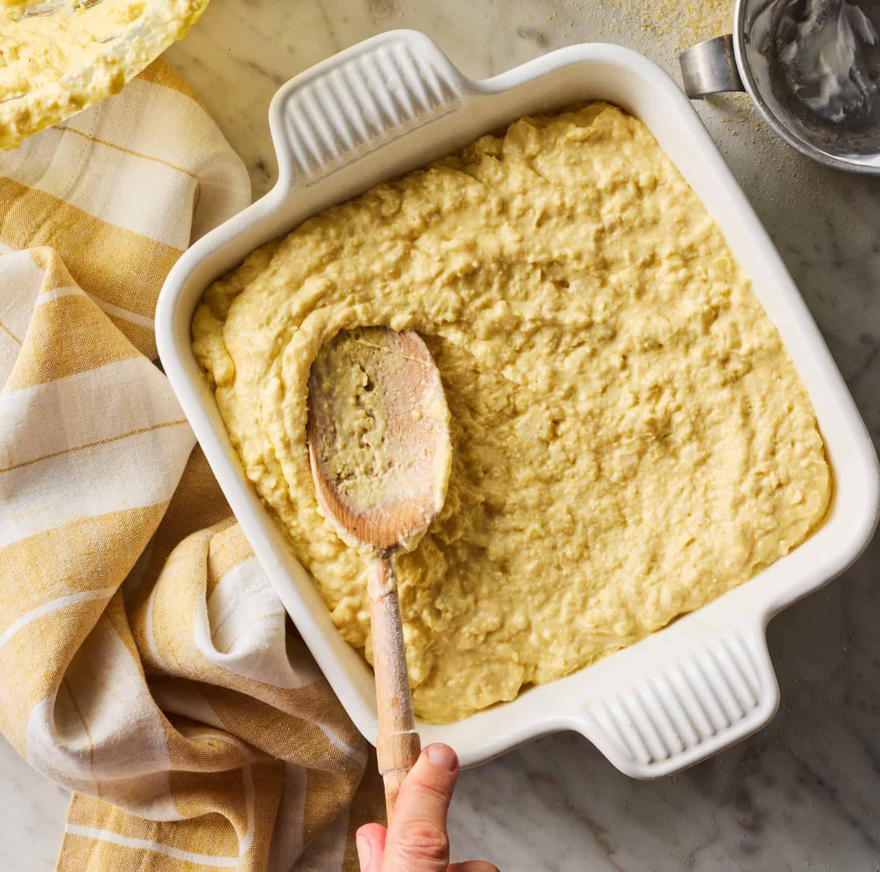 Spreading corn casserole batter evenly in the pan