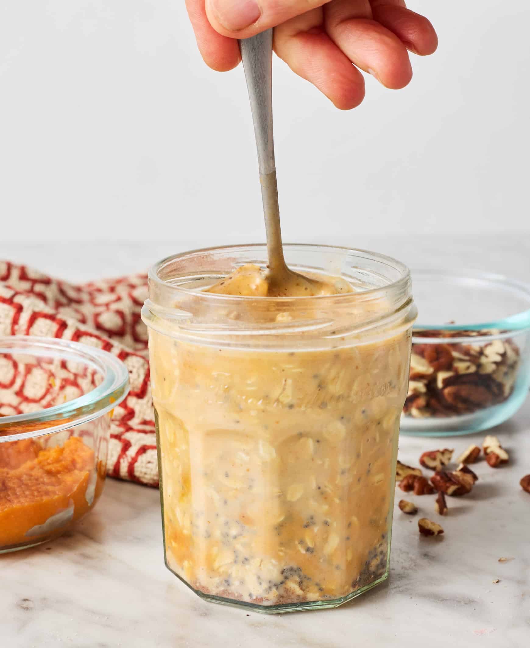 Stirring oat mixture in jar