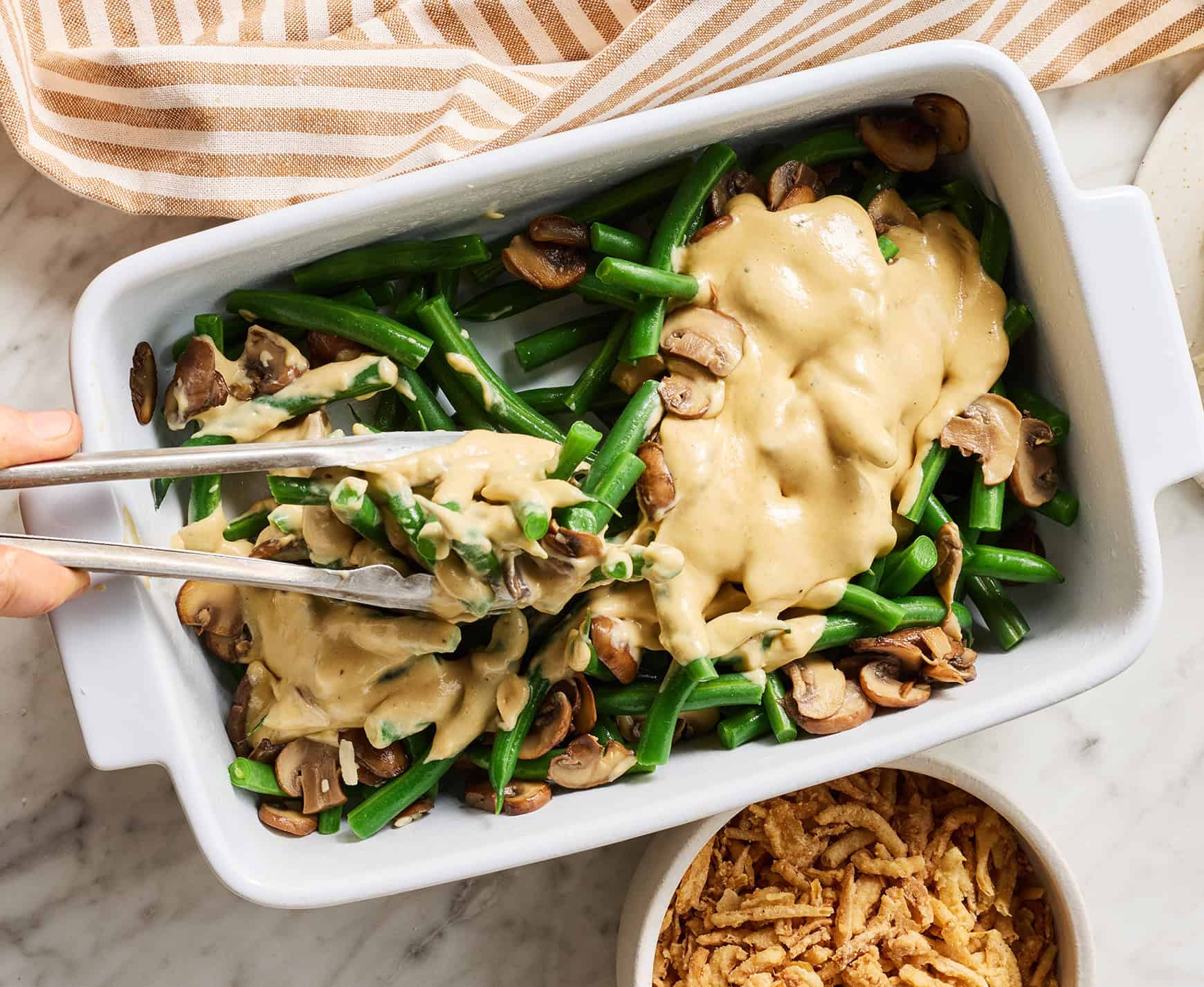 Tossing green beans in sauce