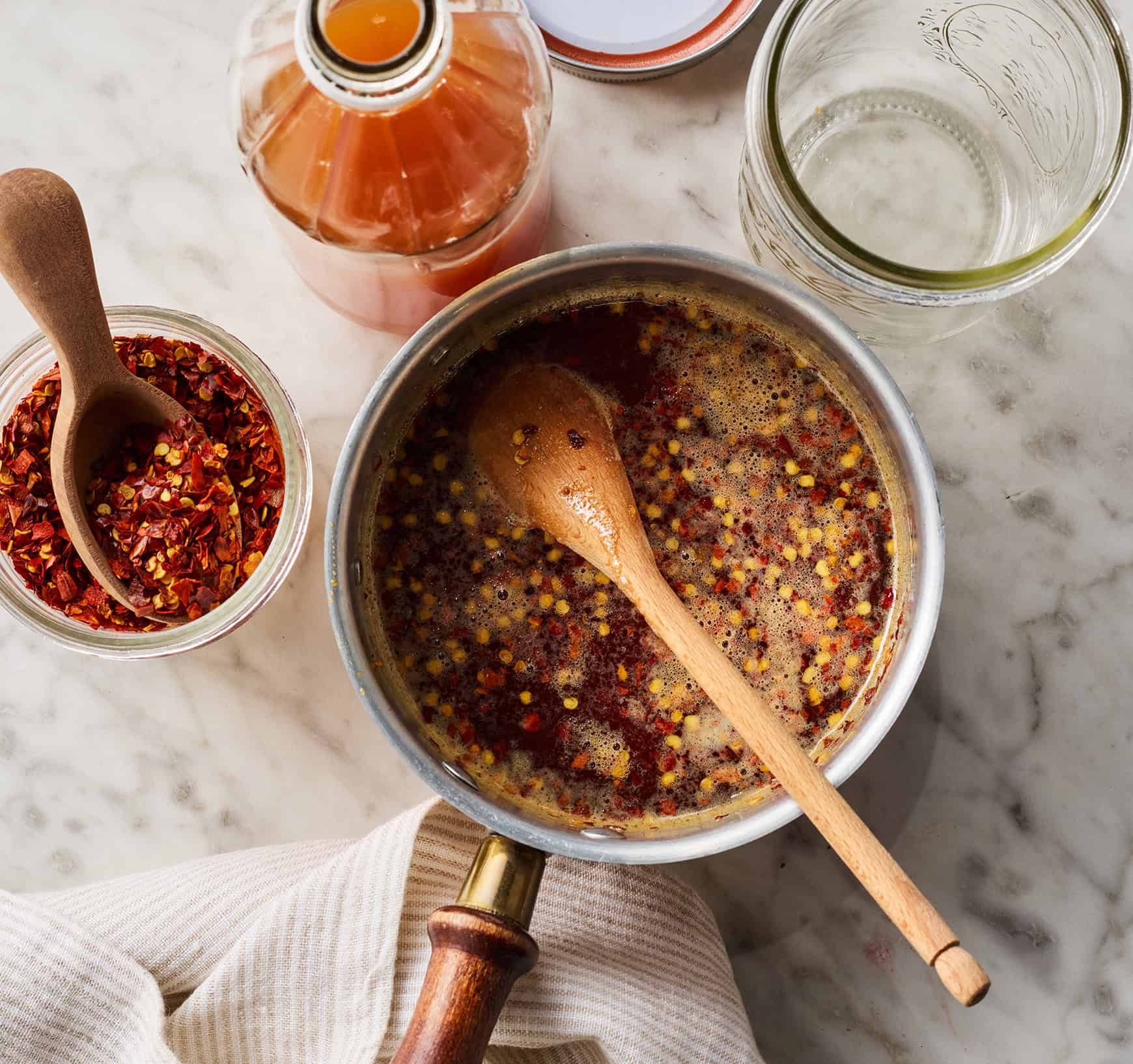 Simmering honey in small saucepan with red pepper flakes