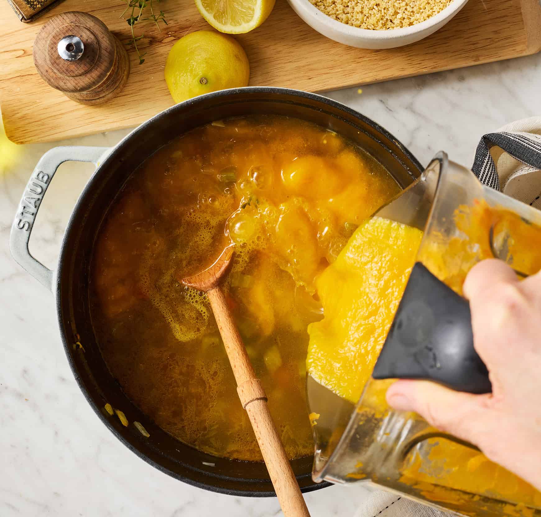 Pouring blended vegetables back into soup pot